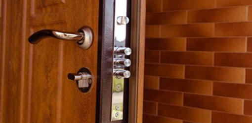 A brown door with 3 locks