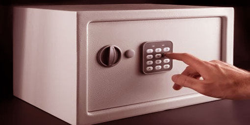 Someone inputting the passcode of a white safe